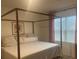 Bright bedroom with a canopy bed frame, neutral bedding, and modern wall art at 3974 Mekong Ct, St Cloud, FL 34772