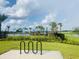 Community pool with shaded umbrellas surrounded by palm trees and new landscaping at 3974 Mekong Ct, St Cloud, FL 34772