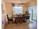 Inviting dining room with a rustic wooden table, chandelier lighting, and ample space for entertaining at 3974 Mekong Ct, St Cloud, FL 34772