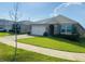 Charming single-story home with a well-manicured lawn and attached two-car garage, and neutral color scheme at 3974 Mekong Ct, St Cloud, FL 34772