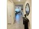 Hallway view leading to an open concept living space with tile flooring and neutral wall tones at 3974 Mekong Ct, St Cloud, FL 34772