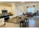 Stylish kitchen featuring granite countertops, stainless steel appliances, and a seamless flow to the dining area at 3974 Mekong Ct, St Cloud, FL 34772