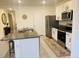Modern kitchen featuring a granite island, stainless steel appliances, and white cabinets at 3974 Mekong Ct, St Cloud, FL 34772