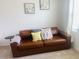 Comfortable living room featuring a leather sofa, plush cushions, and soft carpet at 3974 Mekong Ct, St Cloud, FL 34772