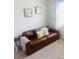 Comfortable living room with a leather sofa, throw pillows, soft carpet and natural light at 3974 Mekong Ct, St Cloud, FL 34772