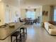 Open concept living and dining area with tile floors, modern lighting, and comfortable seating at 3974 Mekong Ct, St Cloud, FL 34772