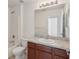Bright bathroom with double sinks, wood cabinets, large mirror, and shower tub combo at 109 James Cir, Lake Alfred, FL 33850