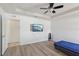 Bedroom features a tray ceiling, laminate floors, a TV, and ample space at 109 James Cir, Lake Alfred, FL 33850