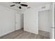Bedroom featuring wood-look floors, a ceiling fan, and ensuite bathroom at 109 James Cir, Lake Alfred, FL 33850