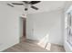 Bedroom featuring wood-look floors, ceiling fan, and natural light from window at 109 James Cir, Lake Alfred, FL 33850
