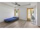 Spacious bedroom with tray ceiling, fan, and natural light from the windows at 109 James Cir, Lake Alfred, FL 33850