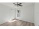 Bedroom featuring wood-look floors, a ceiling fan, and a window with natural light at 109 James Cir, Lake Alfred, FL 33850