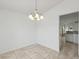 Bright dining room with tile floors and a decorative chandelier at 109 James Cir, Lake Alfred, FL 33850
