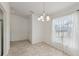 Bright dining room with tile floors and a decorative chandelier at 109 James Cir, Lake Alfred, FL 33850