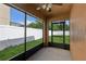 Screened-in lanai featuring privacy fence, and view to green grass at 109 James Cir, Lake Alfred, FL 33850