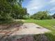 Spacious backyard with a weathered concrete area and scattered trees offering ample open space at 408 S Orange Ave, Fort Meade, FL 33841