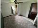 Bedroom featuring carpet, ceiling fan and door to the closet and a view to another room at 408 S Orange Ave, Fort Meade, FL 33841