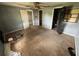 Bedroom featuring outdated carpet, ceiling fan, and view into the bathroom and bedroom at 408 S Orange Ave, Fort Meade, FL 33841