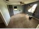 Bedroom featuring outdated carpet and views of the exterior through the windows at 408 S Orange Ave, Fort Meade, FL 33841