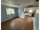 Open layout with dated kitchen featuring white cabinets and laminate counters overlooking the living area at 408 S Orange Ave, Fort Meade, FL 33841