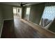 Hardwood floors, neutral wall colors and large windows enhance this inviting living room space at 408 S Orange Ave, Fort Meade, FL 33841