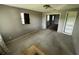 View of the living room with an exterior window, door to a room and built in shelves at 408 S Orange Ave, Fort Meade, FL 33841
