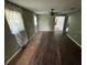 Living room with dark colored walls, wood floors and large windows that provide natural light at 408 S Orange Ave, Fort Meade, FL 33841