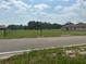 Wide view of the property featuring large grass area and several buildings at 408 S Orange Ave, Fort Meade, FL 33841