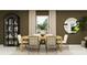 Elegant dining room featuring modern decor, a decorative cabinet, and a window that floods the room with natural light at 967 Hour Glass Rd, Lakeland, FL 33801