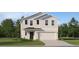 Charming two-story home with a two-car garage and well-manicured front lawn at 999 Hour Glass Rd, Lakeland, FL 33801
