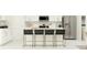 Modern kitchen with white cabinetry, stainless steel appliances, and a kitchen island with barstool seating at 999 Hour Glass Rd, Lakeland, FL 33801
