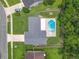A stunning aerial view of the house showcases its spacious backyard, refreshing pool, and well-manicured lawn at 34 Aaron Cir, Ormond Beach, FL 32174