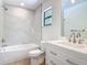 Modern bathroom showcasing marble-look tiled walls and stylish fixtures at 34 Aaron Cir, Ormond Beach, FL 32174