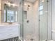 Bathroom with glass enclosed shower featuring tiled walls, niche, and mosaic floor at 34 Aaron Cir, Ormond Beach, FL 32174
