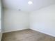 Neutral bedroom featuring wood-look tile flooring and a modern ceiling light at 34 Aaron Cir, Ormond Beach, FL 32174