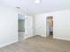 Bedroom with wood-look tile flooring leads to other rooms, and a peek at the ensuite at 34 Aaron Cir, Ormond Beach, FL 32174