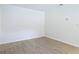 A clean, white bedroom offers wood-look tile flooring and a minimalist design at 34 Aaron Cir, Ormond Beach, FL 32174