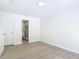 Bedroom features wood-look tile flooring and an open doorway to an ensuite bathroom at 34 Aaron Cir, Ormond Beach, FL 32174
