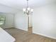 Bright dining area features wood-look tile floors and a stylish chandelier at 34 Aaron Cir, Ormond Beach, FL 32174