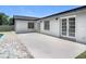 Home exterior showcases a concrete patio and double French doors at 34 Aaron Cir, Ormond Beach, FL 32174