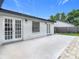 Home exterior view featuring a concrete patio and double French doors at 34 Aaron Cir, Ormond Beach, FL 32174