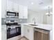 Modern kitchen featuring stainless steel appliances and sleek white cabinetry at 34 Aaron Cir, Ormond Beach, FL 32174