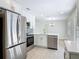 Updated kitchen featuring stainless steel appliances, white cabinetry and modern finishes at 34 Aaron Cir, Ormond Beach, FL 32174
