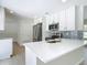 Modern kitchen with white cabinets, stainless steel appliances, and quartz countertops at 34 Aaron Cir, Ormond Beach, FL 32174