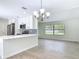 Bright, open kitchen featuring white cabinets, stainless steel appliances, and a stylish backsplash at 34 Aaron Cir, Ormond Beach, FL 32174
