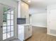 Modern kitchen featuring stainless steel appliances with a door to the backyard at 34 Aaron Cir, Ormond Beach, FL 32174