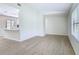 Open floor plan with wood-look tile floors, neutral walls, and kitchen pass-through at 34 Aaron Cir, Ormond Beach, FL 32174
