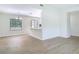 Inviting space with wood-look tile floors, neutral walls, and a view to a bright kitchen at 34 Aaron Cir, Ormond Beach, FL 32174