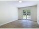 Living space features wood-look tile floors and French doors leading to a backyard pool at 34 Aaron Cir, Ormond Beach, FL 32174