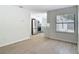 An open concept living space shows bright tile flooring and a view to the kitchen at 34 Aaron Cir, Ormond Beach, FL 32174